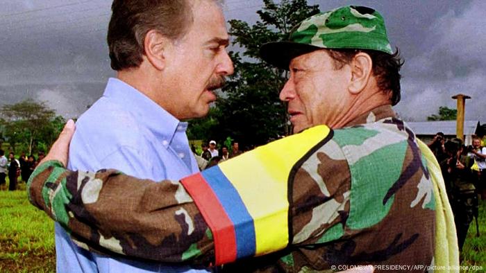 Colombian President Andres Pastrana and FARC leader Manuel Marulanda hug each other