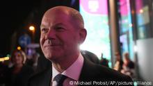 Olaf Scholz, Finance Minister and SPD candidate for Chancellor, leaves after attending a TV broadcast on the parliamentary elections in Berlin, Sunday, Sept. 26, 2021. Exit polls show the center-left Social Democrats in a very close race with outgoing Chancellor Angela Merkel's bloc in Germany's parliamentary election, which will determine who succeeds the longtime leader after 16 years in power. (AP Photo/Michael Probst)
