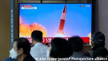 People watch a TV showing a file image of North Korea's missile launch during a news program at the Seoul Railway Station in Seoul, South Korea, Tuesday, Sept. 28, 2021. North Korea on Tuesday fired a suspected ballistic missile into the sea, Seoul and Tokyo officials said, the latest in a series of weapons tests by Pyongyang that raised questions about the sincerity of its recent offer for talks with South Korea. (AP Photo/Ahn Young-joon)