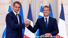 Greek Prime Minister Kyriakos Mitsotakis, left, and French President Emmanuel Macron shake hands after the signing of a new defense deal at The Elysee Palace Tuesday, Sept. 28, 2021 in Paris. France and Greece announced on Tuesday a major, multibillion-euro defense deal including Athens' decision to buy three French warships. (Ludovic Marin, Pool Photo via AP)
