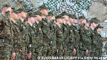 Soldiers of Bosnian armed forces stand at attention during a ceremony in Capljina, on June 12, 2019. - During their departure ceremony, Bosnian armed forces have presented a 10th rotation of infantry men and military police to be dispatched into a peacekeeping mission in Afghanistan, as part of the NATO troops operating in that country. (Photo by ELVIS BARUKCIC / AFP) (Photo credit should read ELVIS BARUKCIC/AFP via Getty Images)
