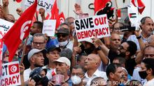 Demonstrators carry flags and banners during a protest against the Tunisian President Kais Saied's seizure of governing powers, in Tunis, Tunisia, September 26, 2021. REUTERS/Zoubeir Souissi