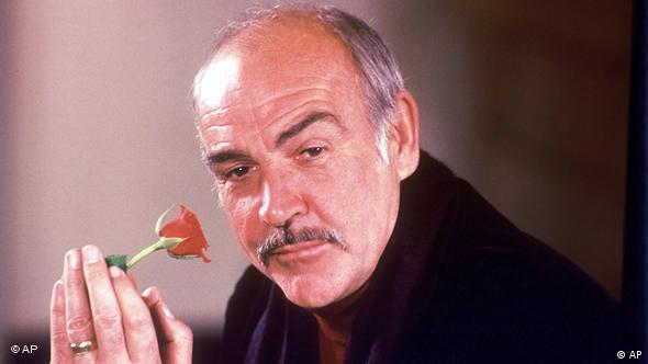 A picture of Sean Connery holding a rose