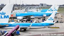 Dutch airline KLM planes are parked on the tarmac of the Schiphol Airport, in the outskirts of Amsterdam, on March 18, 2020 as several airlines cancel their flights related to the Covid-19 outbreak hitting Europe. - Since the virus first emerged in late December, 8,091 people have died around the world, out of more than 199,470 cases according to an AFP tally based on official sources at 1100 GMT on March 18, 2020 (Photo by Remko DE WAAL / ANP / AFP) / Netherlands OUT