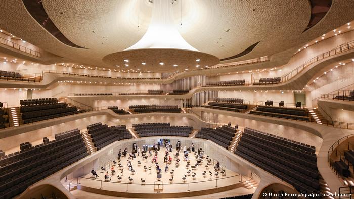 The stage of the Elbphilharmonie dotted with empty chairs 