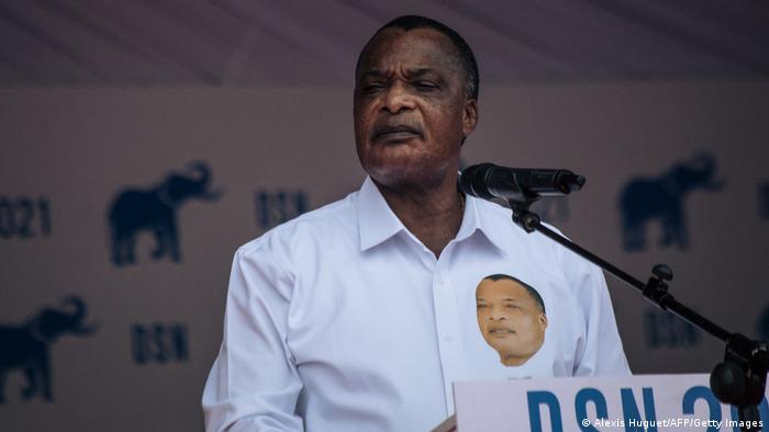Denis Sassou Nguesso delivers a speech in front of a microphone