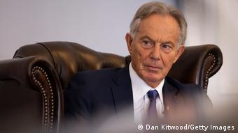 Former Prime Minister Tony Blair sits in a large leather chair, looking out of the frame
