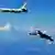 A Su-30 fighter and an H-6K bomber of the Chinese Air Force take part in a drill