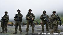 Members of the KFOR peacekeeping force patrol the area near the border crossing between Kosovo and Serbia in Jarinje, Kosovo, October 2, 2021. REUTERS/Laura Hasani
