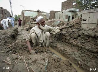 A Pakistani flood survivor rebuilds his house in Nowshera