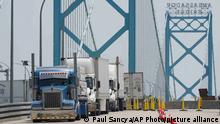 Commercial trucks enter the United States from Canada at the Ambassador Bridge in Detroit, Monday, Aug. 9, 2021.(AP Photo/Paul Sancya)