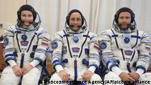 In this handout photo released by Roscosmos, Actress Yulia Peresild, left, director Klim Shipenko' right, and cosmonaut Anton Shkaplerov, members of the prime crew of Soyuz MS-19 spaceship pose at the Russian launch facility in the Baikonur Cosmodrome, Kazakhstan, Sunday, Sept. 19, 2021. In a historic first, Russia is set to launch an actress and a film director to space to make a feature film in orbit. Actress Yulia Peresild and director Klim Shipenko are set to blast off Tuesday for the International Space Station in a Russian Soyuz spacecraft together with Anton Shkaplerov, a veteran of three space missions. (Roscosmos Space Agency via AP)