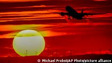 An aircraft takes off at the international airport in Frankfurt, Germany, as the sun sets Monday, Oct.4, 2021. (AP Photo/Michael Probst)