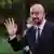 Charles Michel waves to reporters as he arrives to a summit in Slovenia