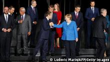 France's President Emmanuel Macron (CL), Germany's Chancellor Angela Merkel (CR), Eu members states and Western Balkans partners' representants pose as they arrive at the EU-Western Balkans summit at Brdo Castle in Kranj on October 5, 2021. - EU leaders will have a hard discussion on Europe's place in the world at a summit, as they seek unity on how to deal with superpowers China and the United States. The 27 heads of state and government will meet at Brdo Castle in Slovenia, the country that currently holds the EU's rotating presidency. (Photo by Ludovic MARIN / AFP) (Photo by LUDOVIC MARIN/AFP via Getty Images)