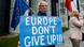 A man holds a sign 'Europe don't give up!" A man holds a sign 'Europe don't give up!"