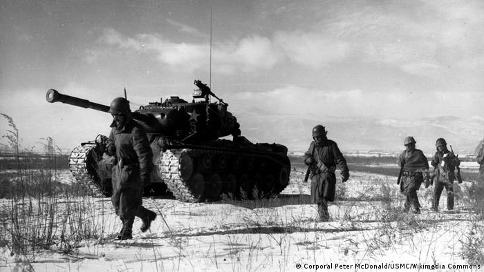 A column of troops and armor of the 1st Marine Division move through communist Chinese lines during their successful breakout from the Chosin Reservoir