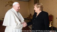 Pope Francis receives German Chancellor Angela Merkel, right, in his Library at the Vatican, Thursday, Oct. 7, 2021. (Vatican Media via AP)