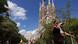 People walking with the Sagrada Familia in the background People walking with the Sagrada Familia in the background