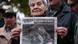 An elderly woman holds a portrait of Russian journalist Anna Politkovskaya