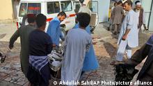 People carry the body of a bombing victim in Kunduz province, northern Afghanistan, Friday, Oct. 8, 2021. A powerful explosion in a mosque frequented by a Muslim religious minority in northern Afghanistan on Friday has left several casualties, witnesses and the Taliban's spokesman said. (AP Photo/Abdullah Sahil)