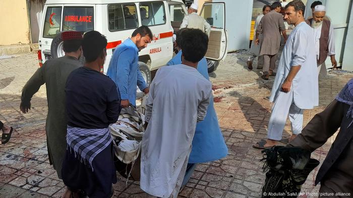 Men carry people who have been injured in a bombing in Kunduz to an ambulance