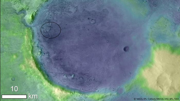 The lighter colors represent a greater height in this image of Jezero crater on Mars, the landing site for NASA's Mars 2020 mission.  The oval indicates the landing ellipse.