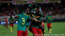 Cameroon striker Choupo-Moting (R-Front) is celebrated by teammates after scoring agains Mozambique during the FIFA World Cup Qatar 2022 qualifying round Group D football match between Cameroon and Mozambique in Douala on October 11, 2021. (Photo by Daniel BELOUMOU OLOMO / AFP)