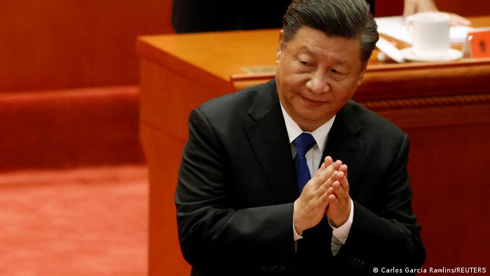 Chinese President Xi Jinping applauds at a meeting commemorating the 110th anniversary of Xinhai Revolution