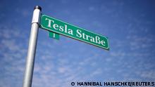 FILE PHOTO: A sign that reads Tesla Street is pictured outside the construction site of the future Tesla Gigafactory, in Gruenheide near Berlin, Germany, August 12, 2021. REUTERS/Hannibal Hanschke/File Photo