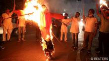 FILE PHOTO: Protestors burn an effigy of Yogi Adityanath, Chief Minister of the northern state of Uttar Pradesh, during a protest after people were killed when a car linked to a federal minister ran over farmers protesting against controversial farm laws in Uttar Pradesh on Sunday, in Kolkata, India, October 4, 2021. REUTERS/Rupak De Chowdhuri/File Photo