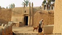 A house made of dried mud in the old part of Kano, one of the major Hausa-Fulani city states of northern Nigeria. The section around the doorway has been rebuilt using recently introduced mud bricks. Country of Origin: Nigeria. Culture: Hausa. Period/ Date: early 1960's. Place of Origin: Northern Nigeria. Credit Line: Werner Forman Archive. Location: 01. (Werner Forman Archive / Heritage Images)