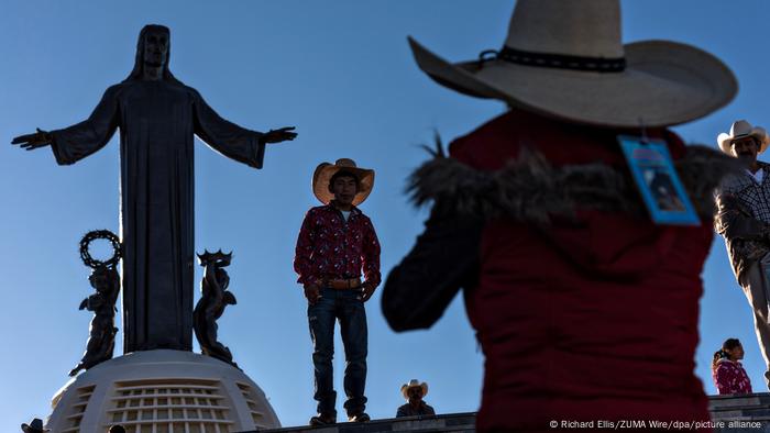 Cowboys take a photo in front of the Cristo Rey in Guanajuato, Mexico