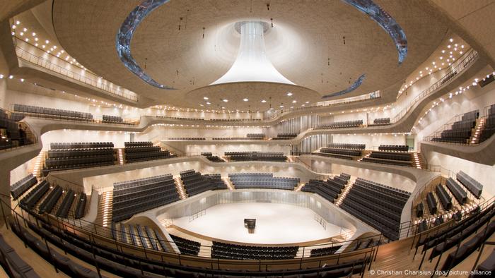 Suspended sound reflector over a large concert hall.