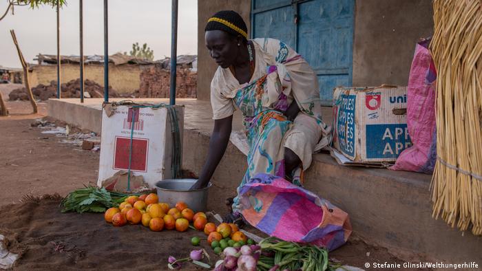 A woman selling fruits in a village market in South Sudan