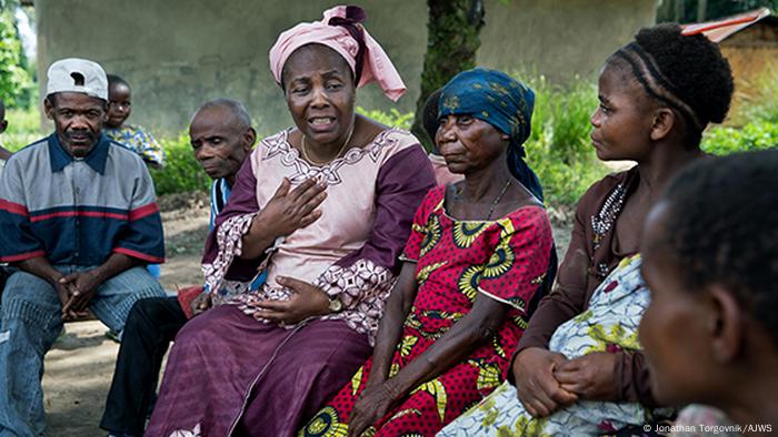 Julienne Lusenge sits surrounded by survivors of conflict violence