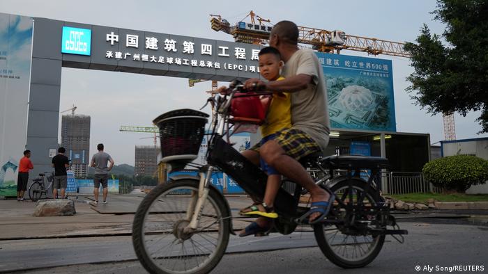 Cyclists passing a construction site in China