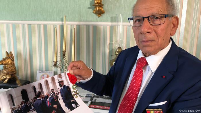Serge Carel holds photo of him and Macron meeting Serge Carel holds photo of him and Macron meeting