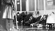 Anti-Curfew Demonstrations : 20th October 1961 Algerian Moslems many with hands on their heads are guarded by a French security officer after being arrested in Paris during clashes which left many injured and killed. France / Mono Print
