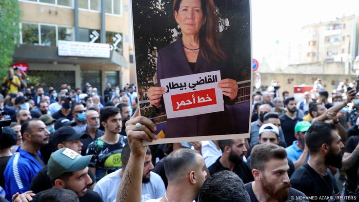 A supporter of Hezbollah holds up a picture of US Ambassador to Lebanon Dorothy Shea during a protest against Judge Tarek Bitar