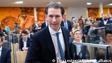 Sebastian Kurz, the former Austrian Chancellor, takes his seat for the sworn-in as deputy in the Austrian Parliament in Vienna, Austria, Thursday, Oct. 14, 2021. (AP Photo/Lisa Leutner)
