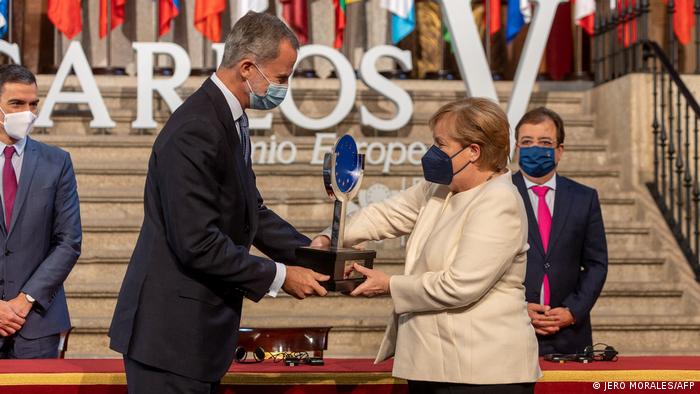 Germany's Chancellor Angela Merkel (R) receives the Carlos V European Award from Spain's King Felipe VI during a ceremony at the Royal Monastery of Yuste