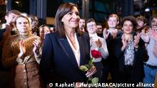 Anne Hidalgo holds a red rose as she acknowledges the applause during the result of the vote of the Socialist Party nominating her as their candidate for the 2022 French presidential election