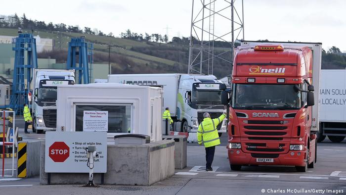 Customs officers check cargo lorries as they disembark from a ferry at the Northern Irish port of Larne. 