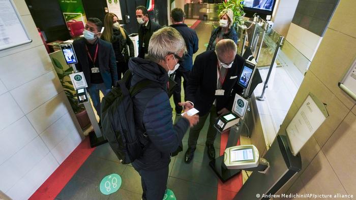 Italians scanning their green pass at train company offices