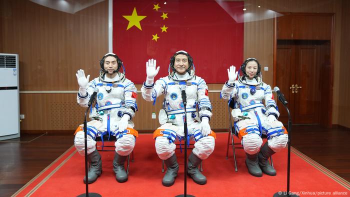 Three Chinese astronauts answer questions as they prepare to go to space on a six month mission