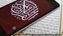 2018****
Digital quran on a smartphone and Holy Quran book. Close-up.