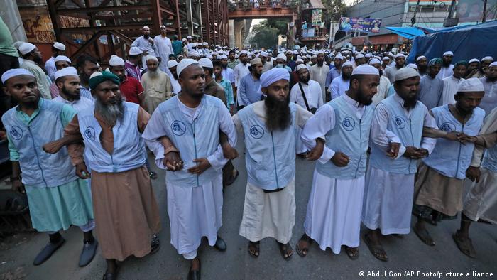 Muslims lock hands during a protest over an alleged insult to Islam