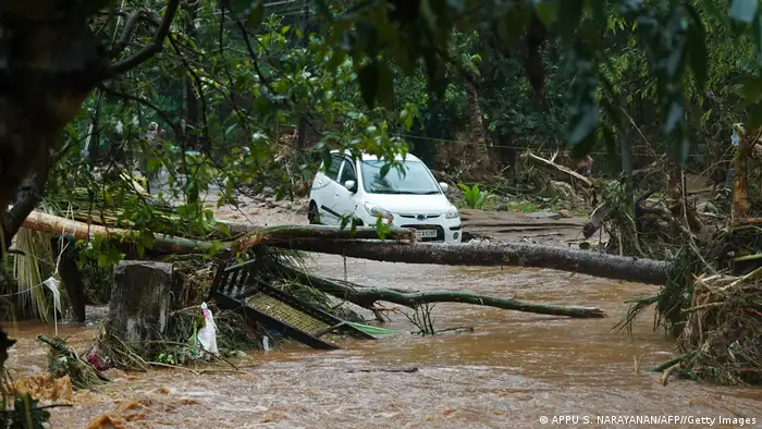 A car stuck in muddy waters is pictured after flash floods caused by heavy rains