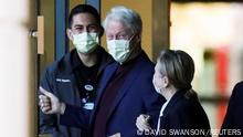 Former U.S. President Bill Clinton, accompanied by his wife, former Secretary of State Hillary Clinton, walks out of University of California Irvine Medical Center, in Orange, California, U.S. October 17, 2021. REUTERS/David Swanson